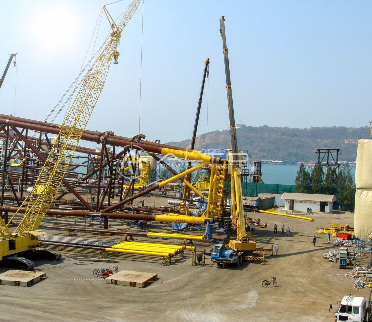 An offshore steel jacket foundation structure under fabrication at a heavy industrial construction yard, where precise dimensional inspection is required to ensure structural integrity.