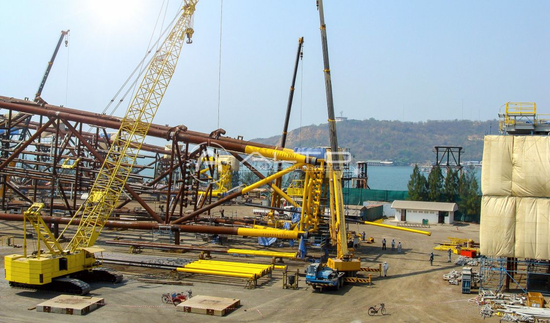 An offshore steel jacket foundation structure under fabrication at a heavy industrial construction yard, where precise dimensional inspection is required to ensure structural integrity.