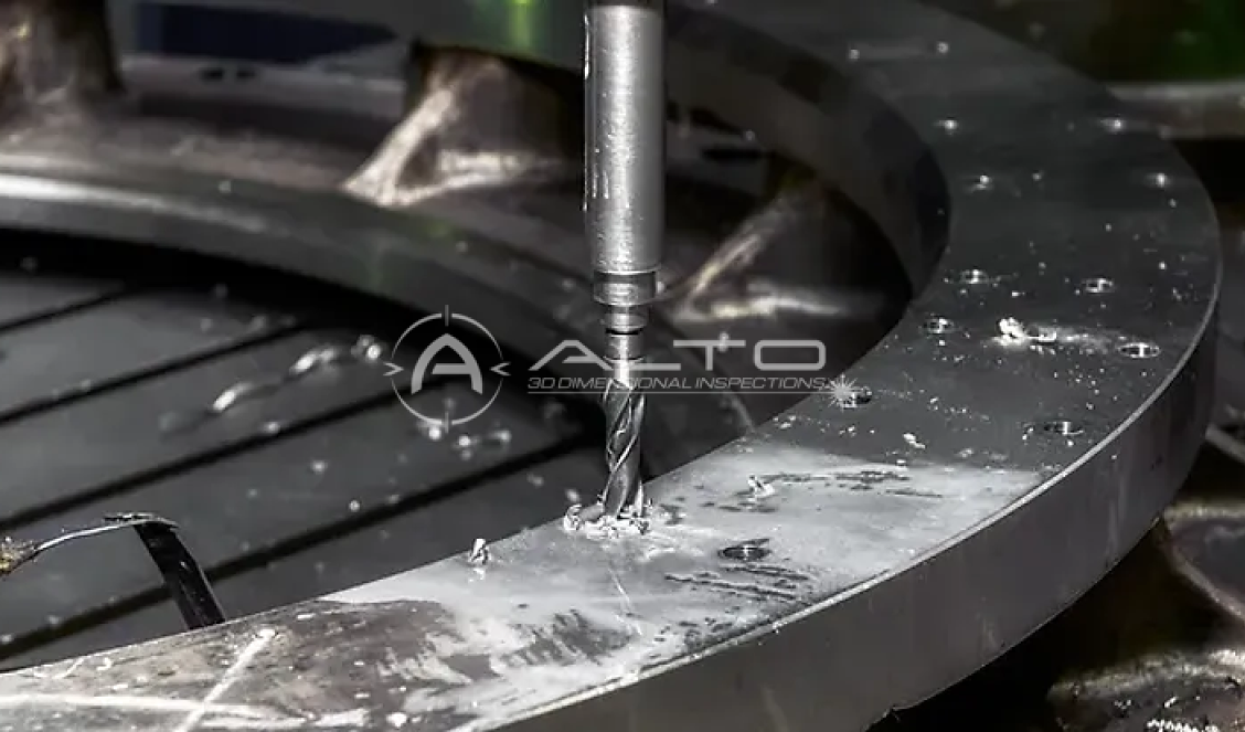 A vertical milling tool drilling a bolt hole into a large circular steel flange during on-site machining, illustrating the precise alignment and real-time process monitoring required for industrial equipment installations.